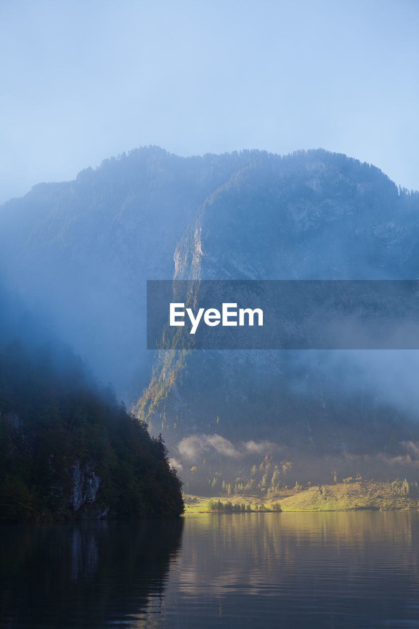 Scenic view of lake and mountains against clear sky