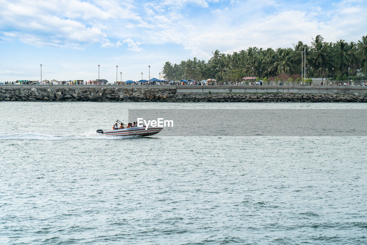 water, nautical vessel, transportation, mode of transportation, sea, boating, sky, nature, travel, vehicle, boat, cloud, day, travel destinations, architecture, bay, waterfront, holiday, vacation, trip, outdoors, tourism, tree, city, watercraft, shore, environment, beauty in nature, built structure, scenics - nature, blue, rippled, sailing, landscape, tropical climate, land, beach, plant, tourist, craft, tranquility