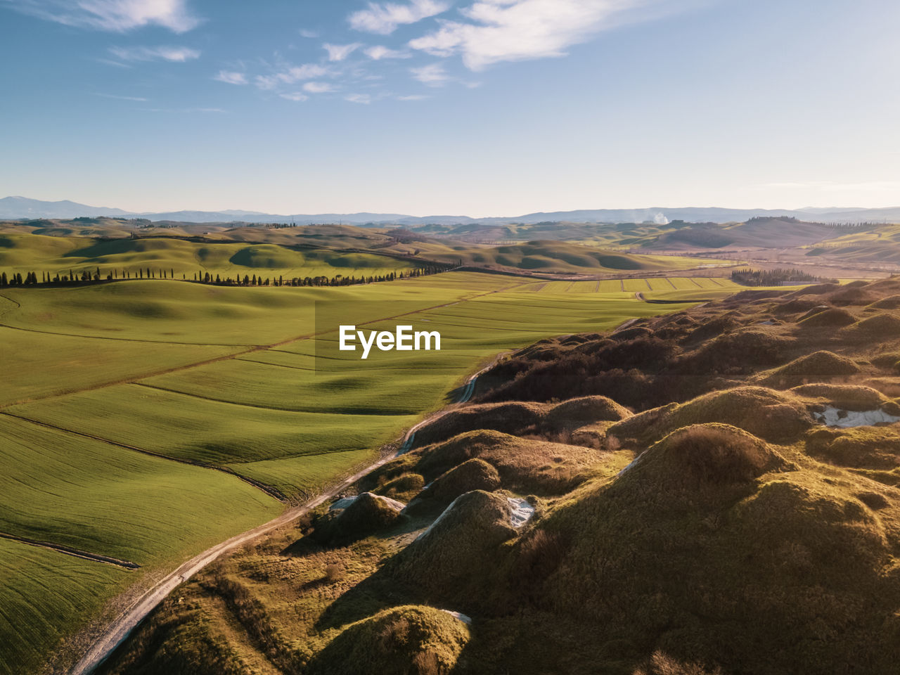 AERIAL VIEW OF AGRICULTURAL LANDSCAPE AGAINST SKY