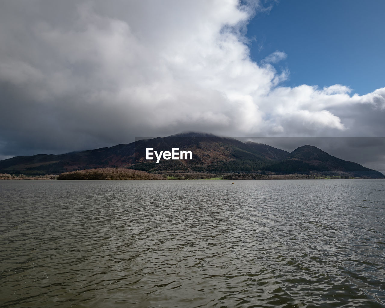 Scenic view of sea and mountains against sky