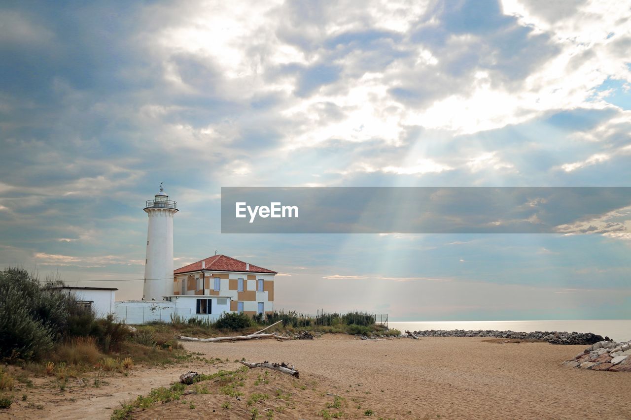 Scenic view of beach by sea against sky