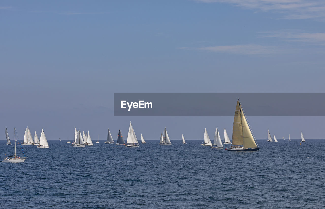 SAILBOAT SAILING IN SEA AGAINST SKY