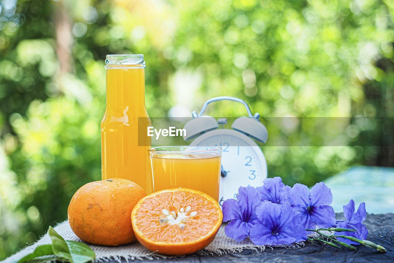 VIEW OF ORANGE AND WINE IN GLASS
