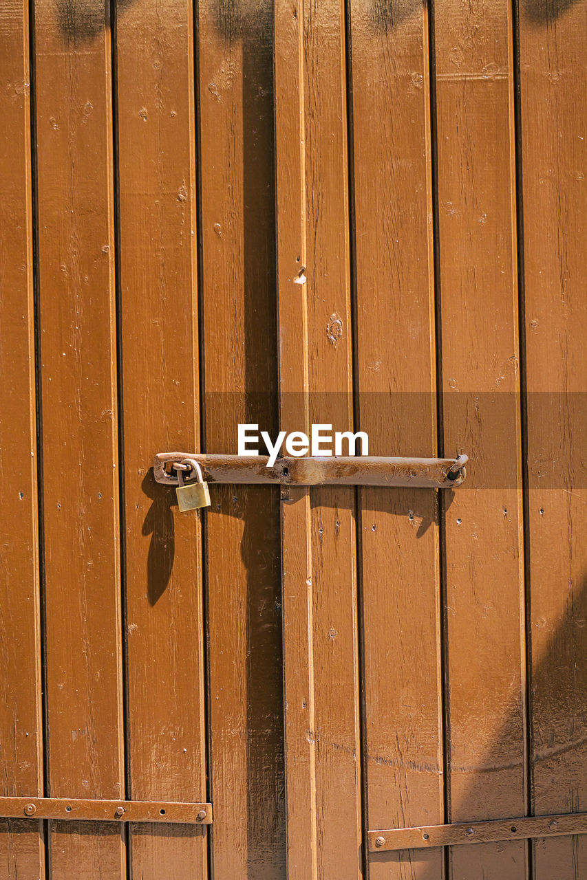 Full frame shot of closed brown wooden door