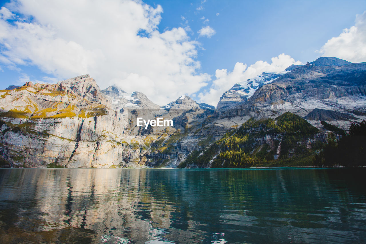 Scenic view of lake and snowcapped mountains against sky