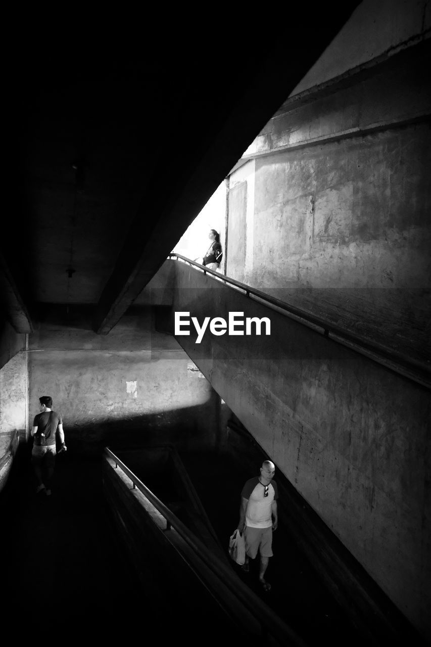 VIEW OF PEOPLE WALKING ON ESCALATOR