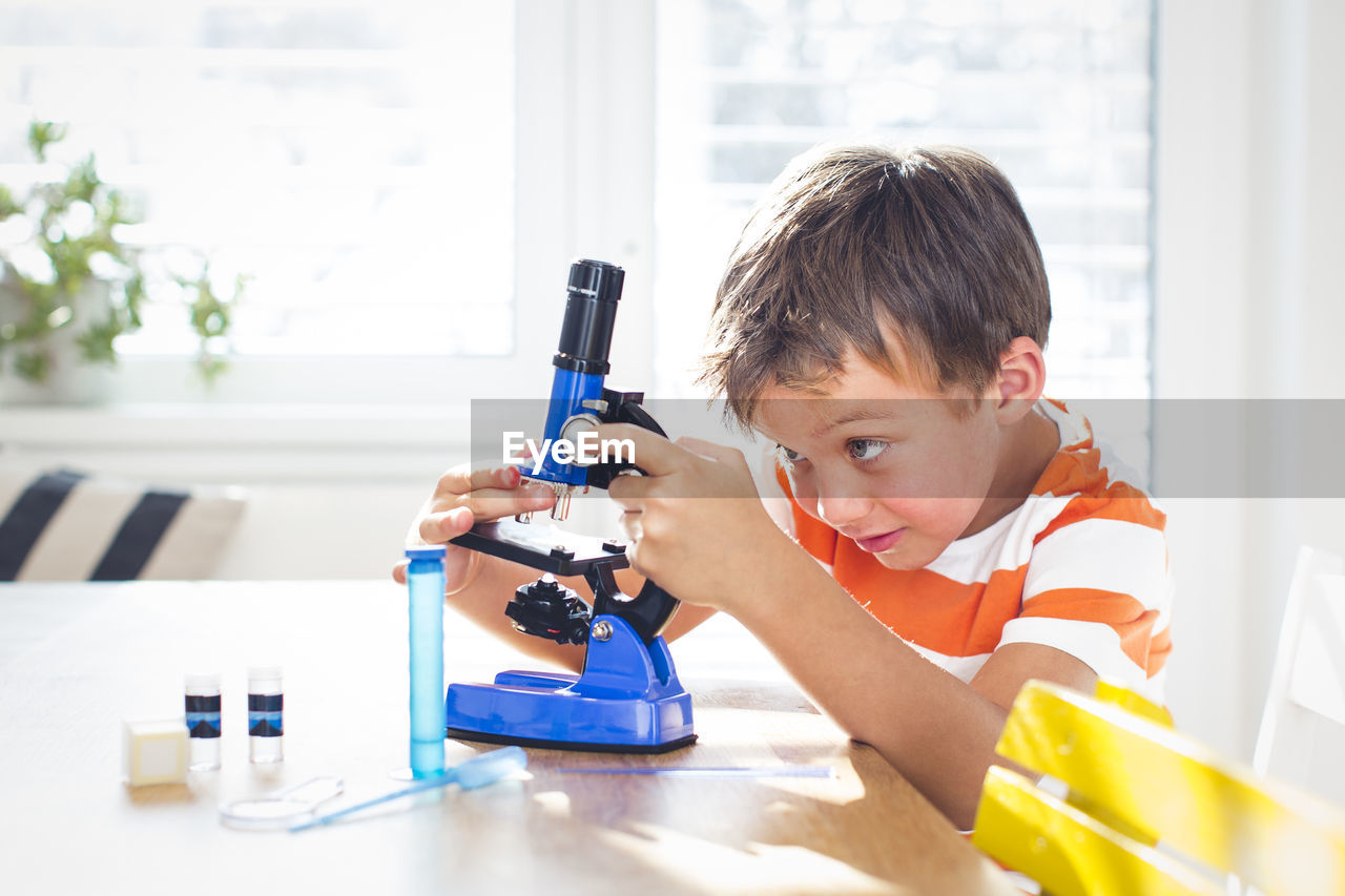 Boy doing science experiment at home