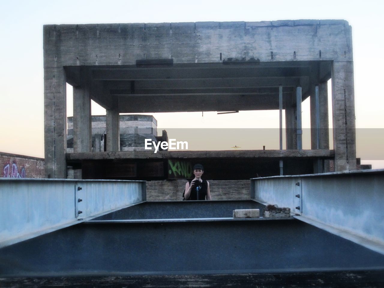 WOMAN STANDING ON BRIDGE