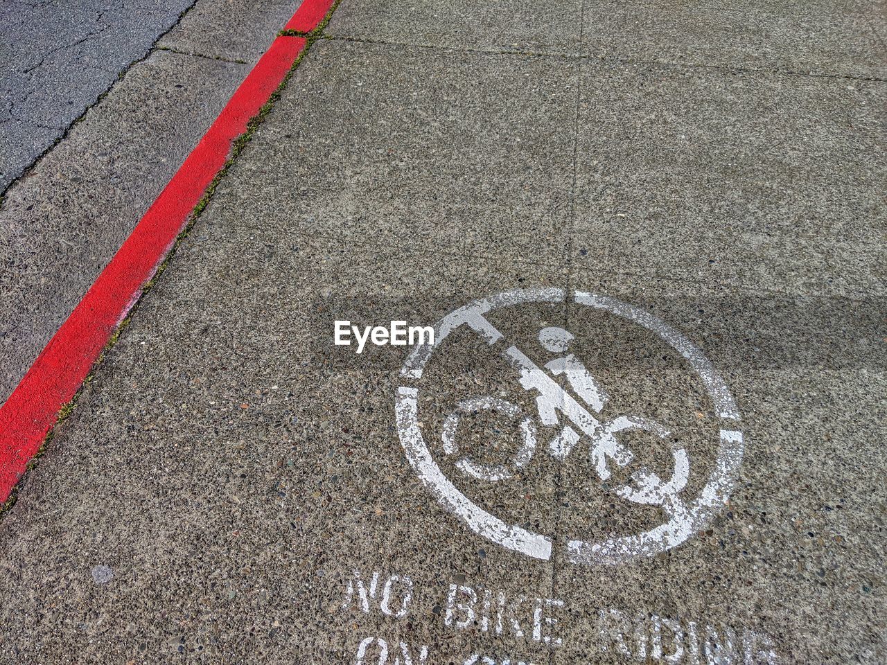 High angle view of bicycle sign on road. not allowed. 