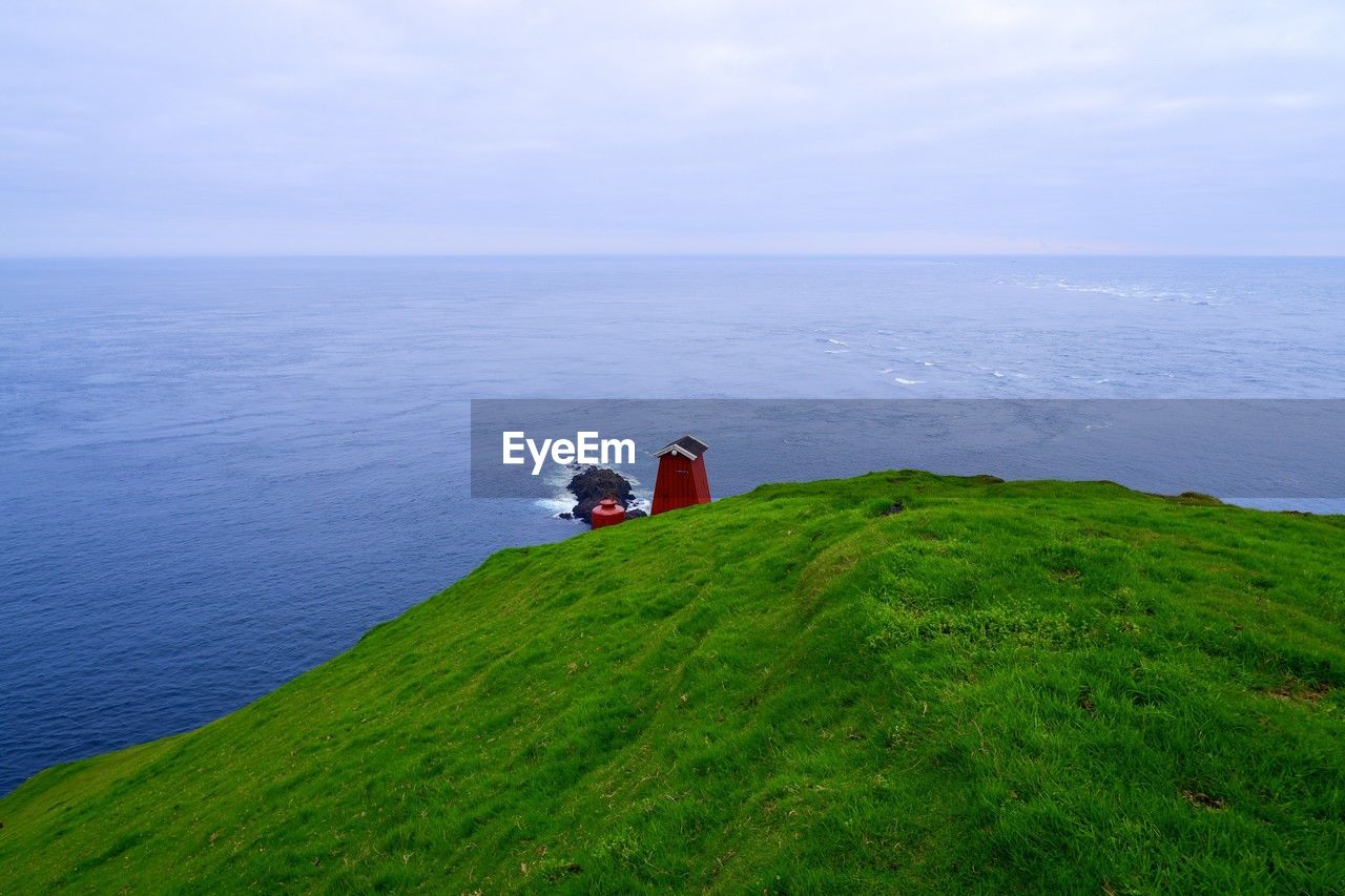 water, sea, beauty in nature, horizon, scenics - nature, cliff, coast, sky, horizon over water, hill, nature, ocean, land, terrain, tranquility, tranquil scene, day, grass, beach, non-urban scene, plant, shore, idyllic, green, cloud, two people, outdoors, travel, leisure activity, bay, high angle view, men, lifestyles, tower, environment, holiday, trip, vacation, adult, travel destinations, landscape, women, remote