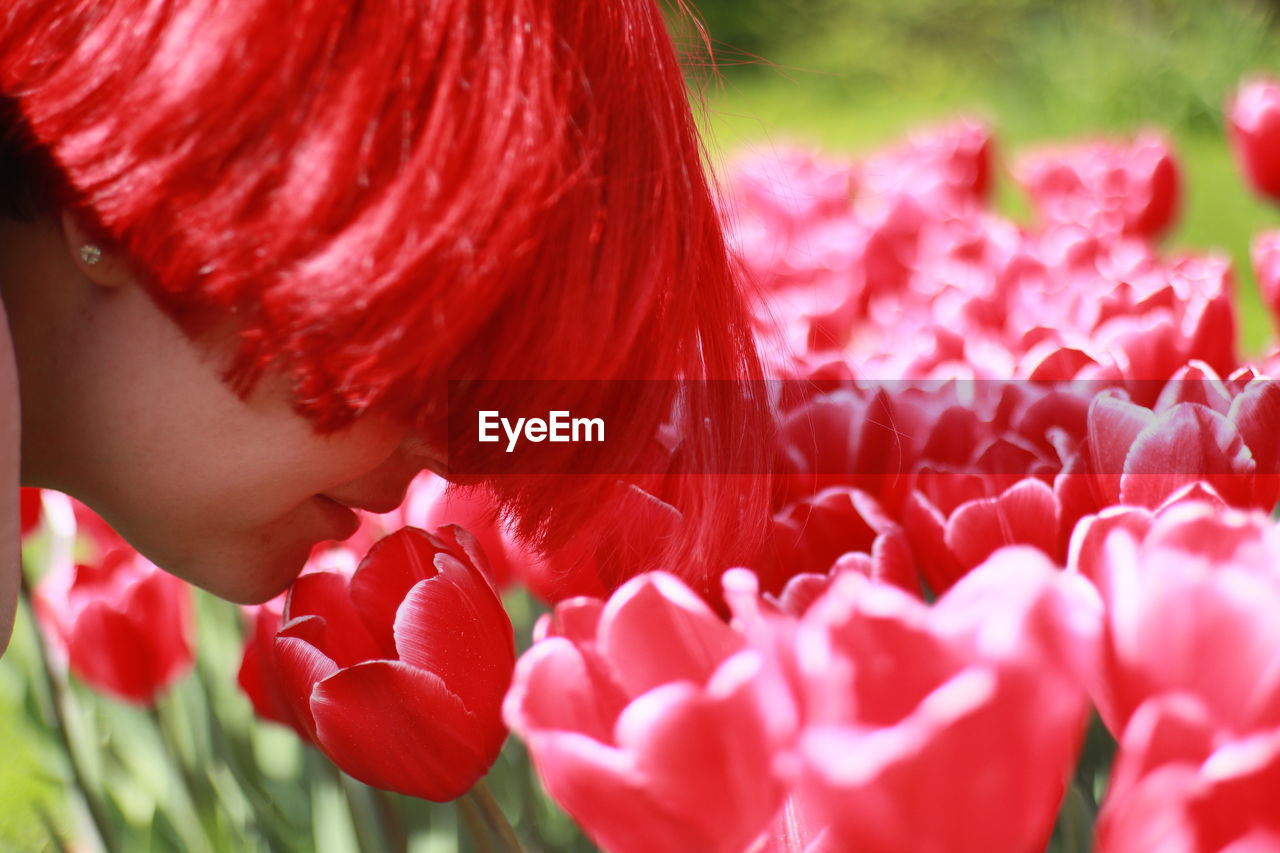 close-up of young woman with pink flowers