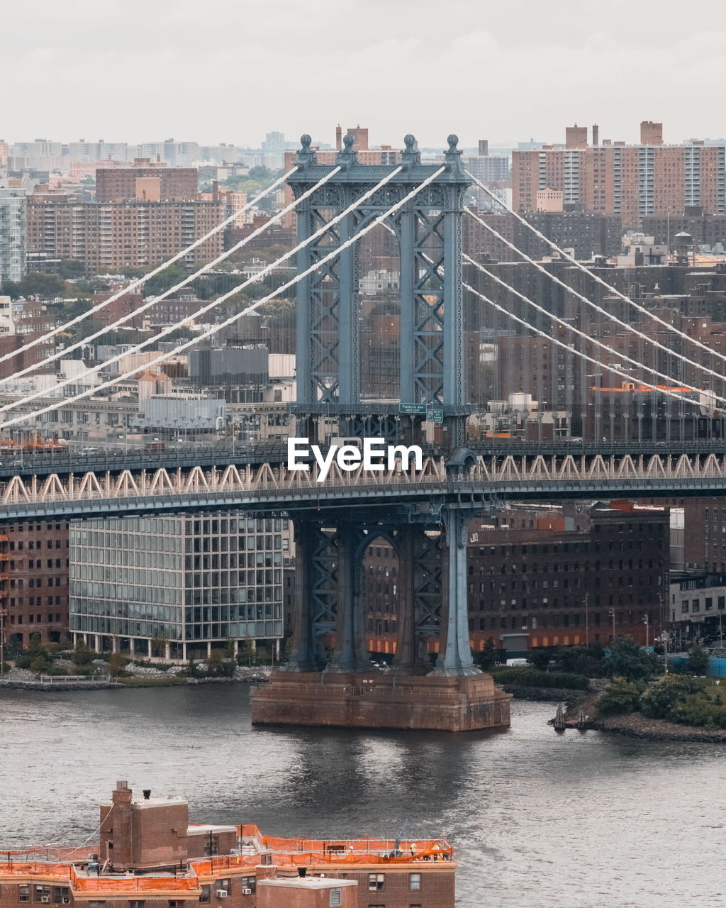 Bridge over river with buildings in background