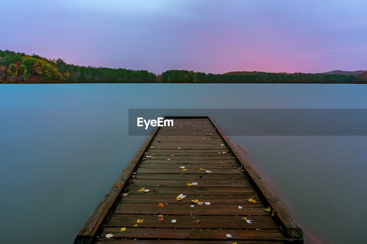 Pier over lake against sky