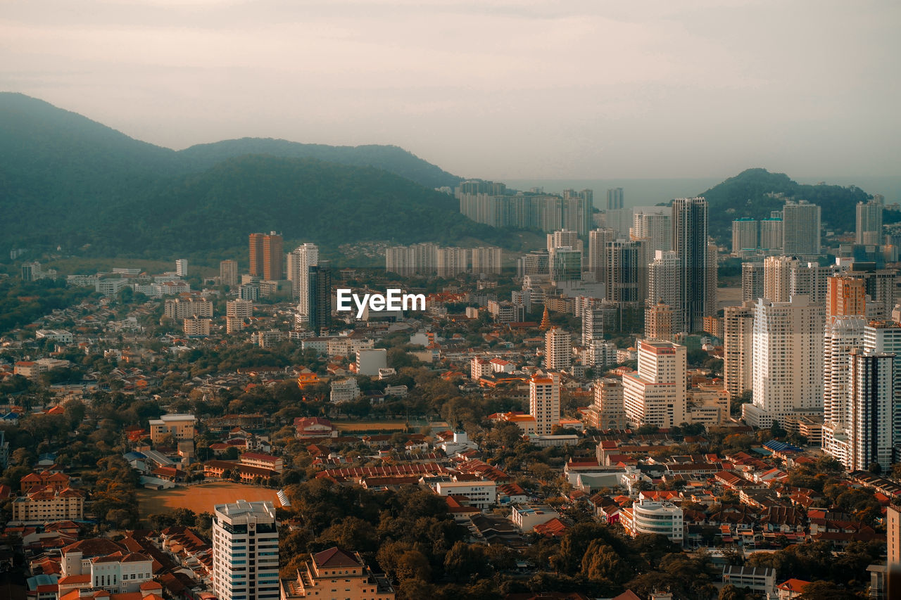 Aerial view of cityscape against sky during sunset