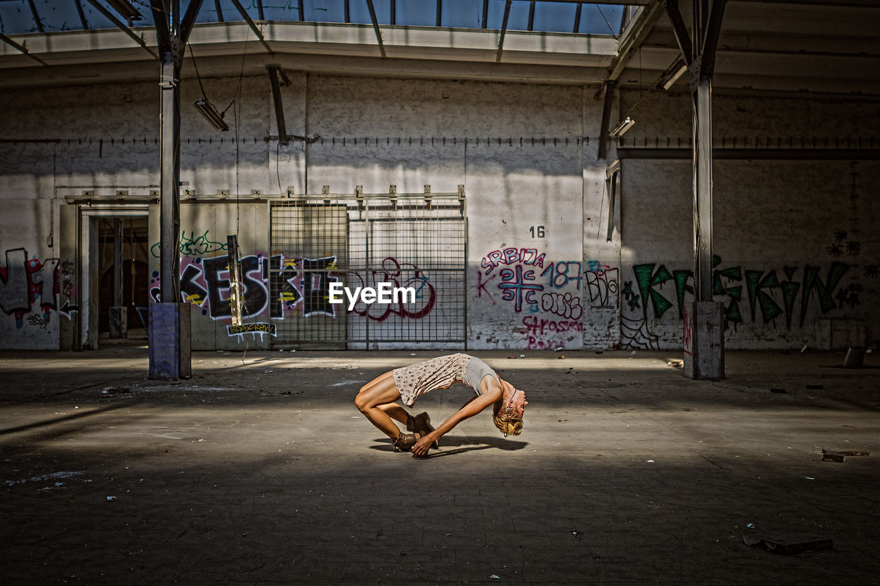 MAN WITH GRAFFITI ON WALLS