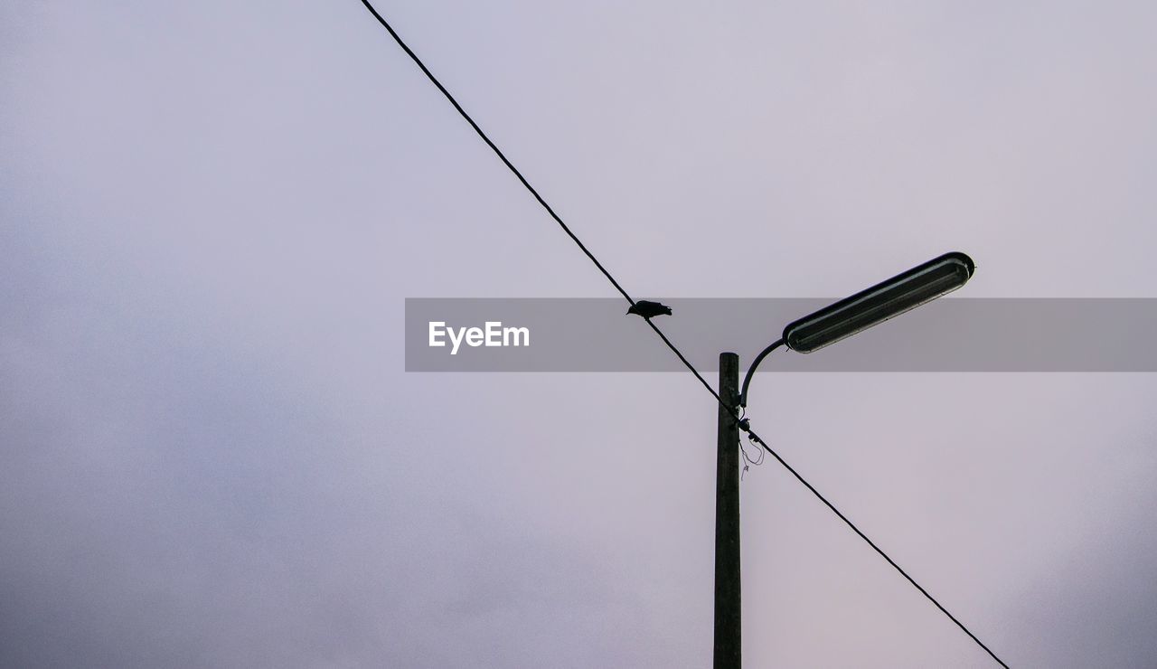 LOW ANGLE VIEW OF POWER LINES AGAINST SKY