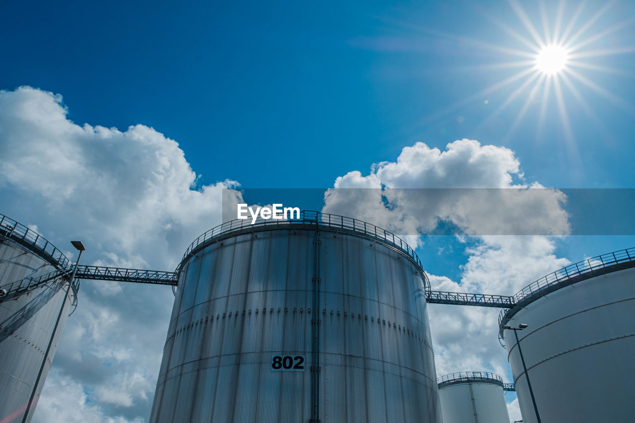 LOW ANGLE VIEW OF SMOKE STACKS AGAINST SKY