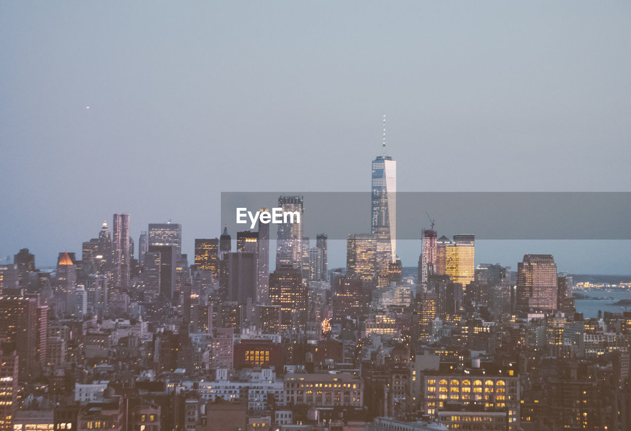 Aerial view of modern buildings in city against clear sky