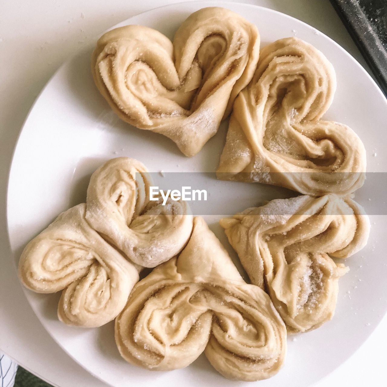 Directly above shot of raw pastry item in plate on table