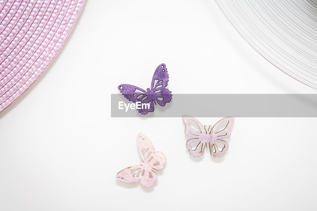 High angle view of butterfly shaped decorations on white background