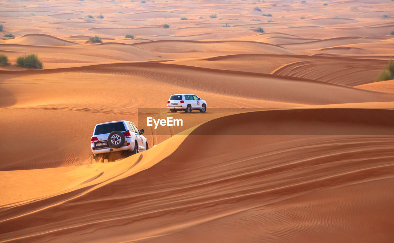 High angle view of off-road vehicles on sand dunes