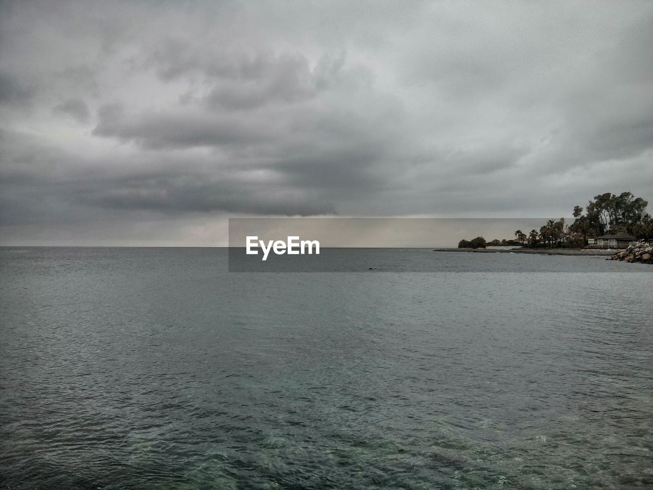 VIEW OF SEA AGAINST CLOUDY SKY