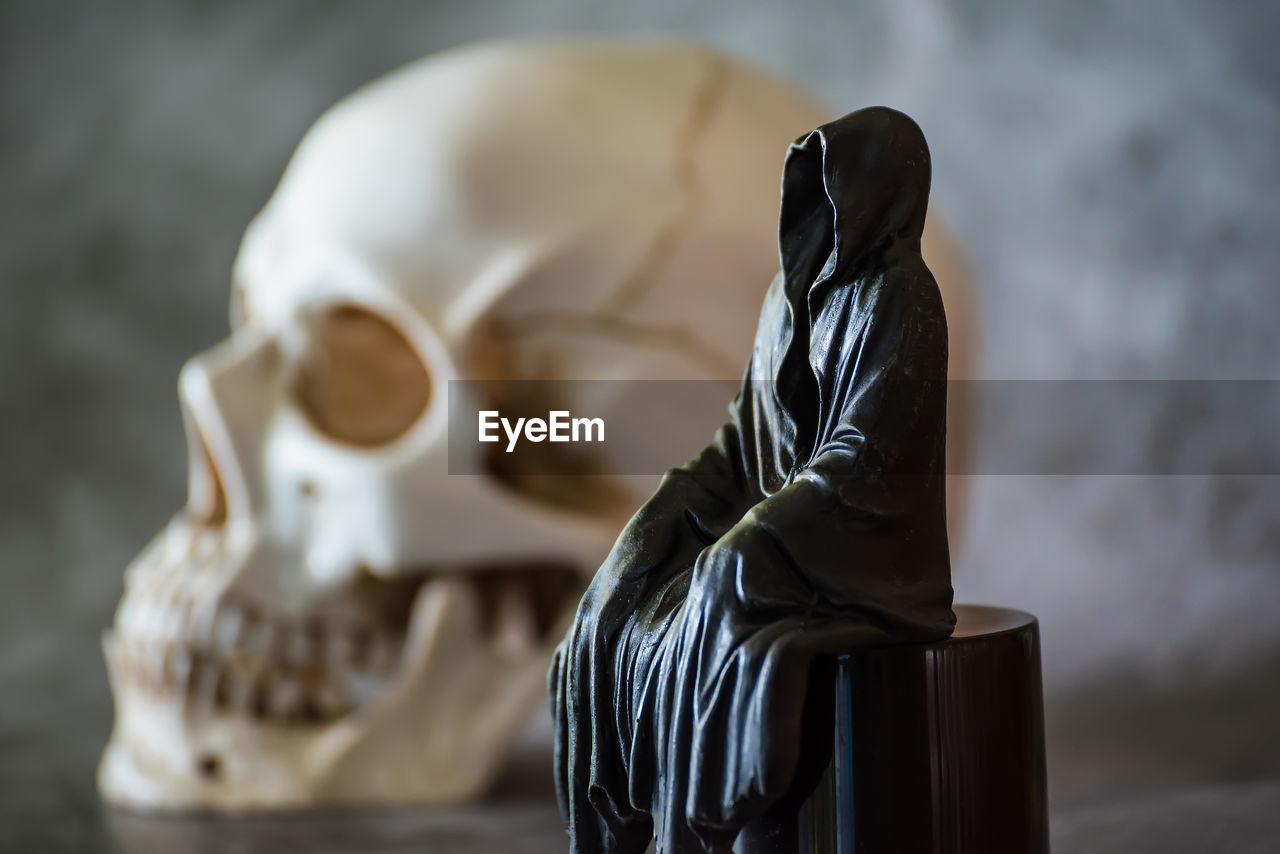 sculpture, art, black, indoors, bone, no people, white, close-up, death, focus on foreground, statue, human skeleton