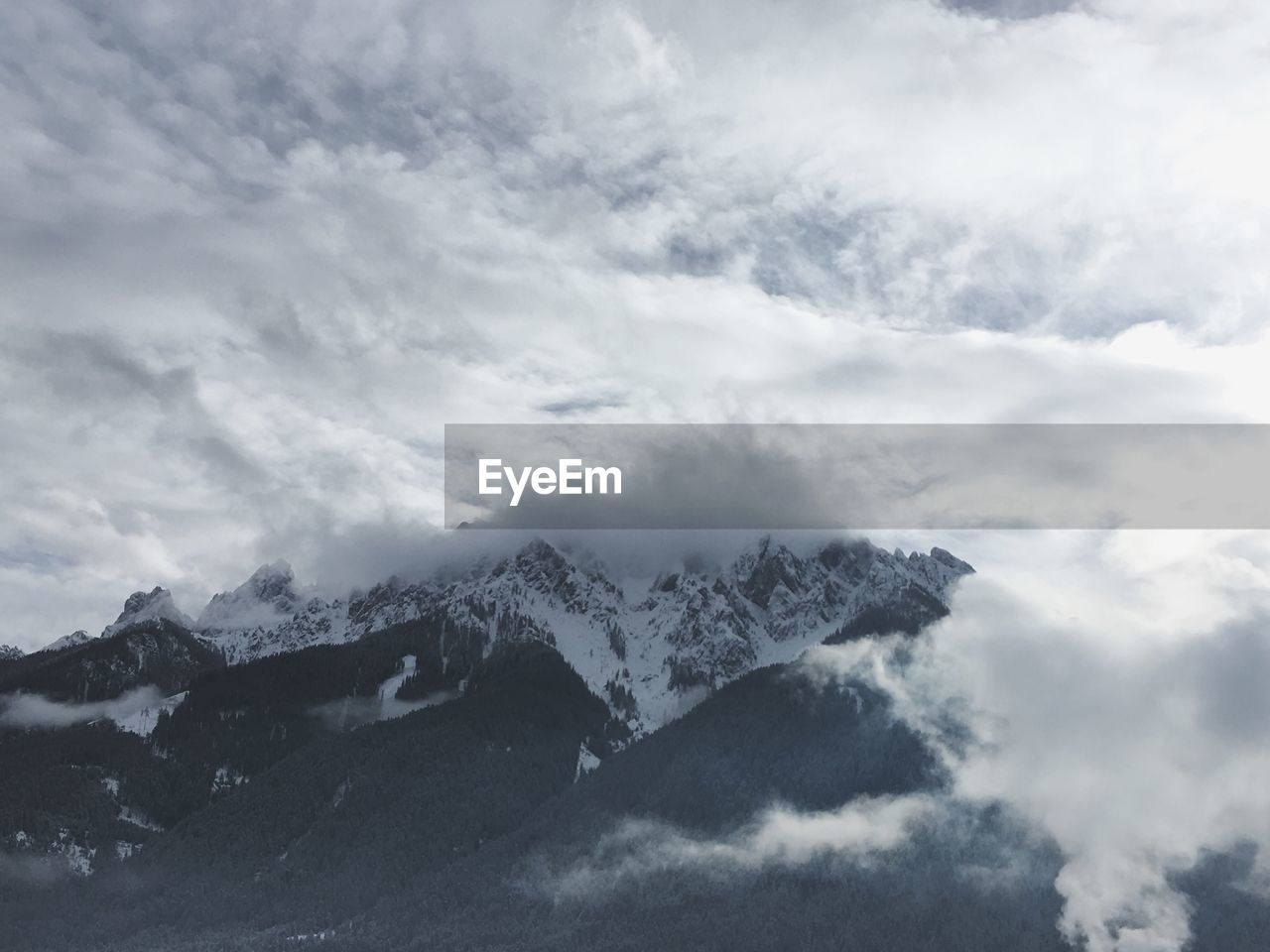 LOW ANGLE VIEW OF MOUNTAINS AGAINST SKY DURING WINTER