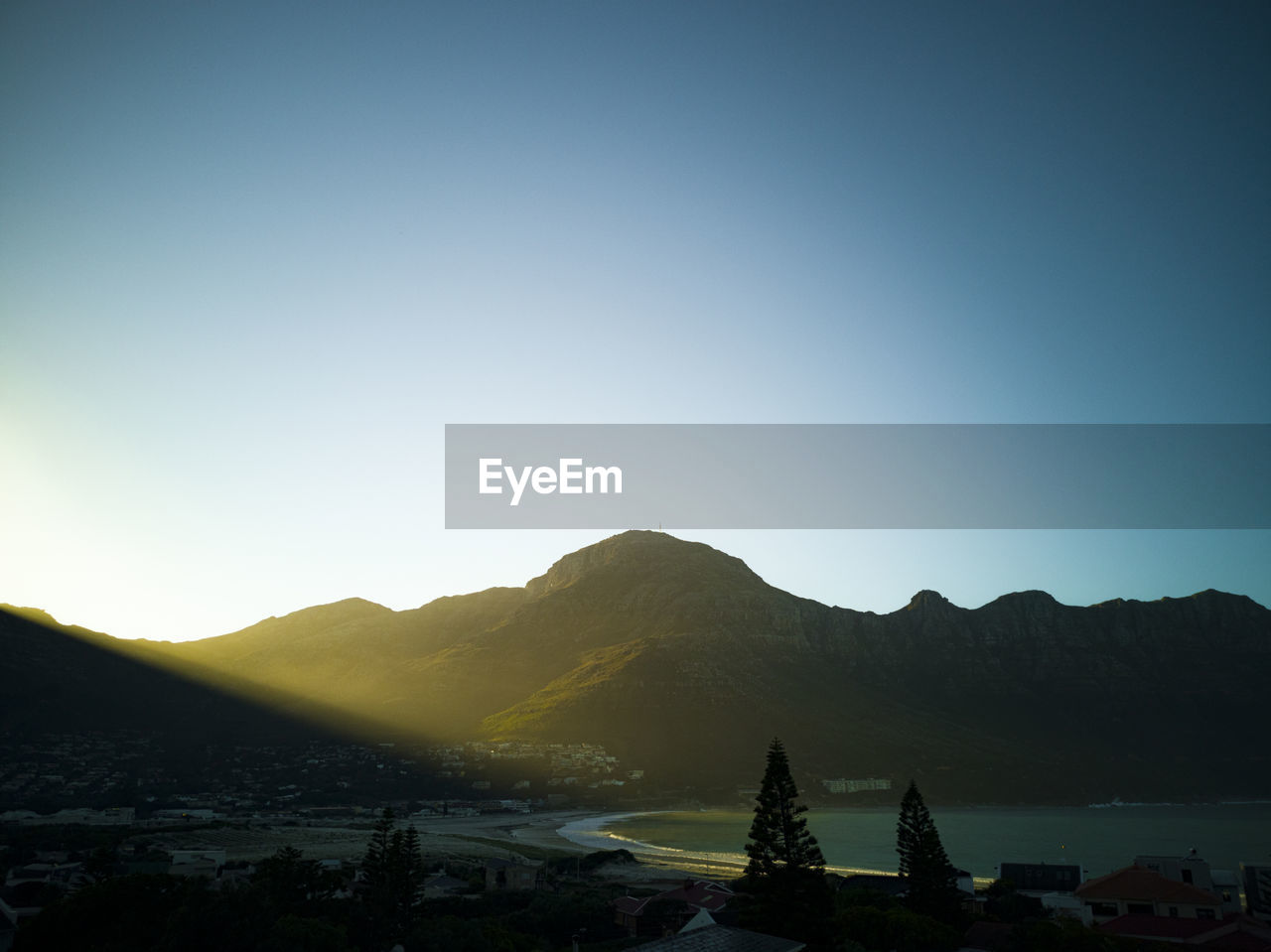 Scenic view of mountains against clear blue sky