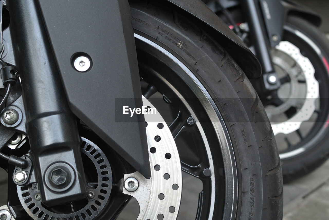 CLOSE-UP OF WHEEL SEEN THROUGH CAR