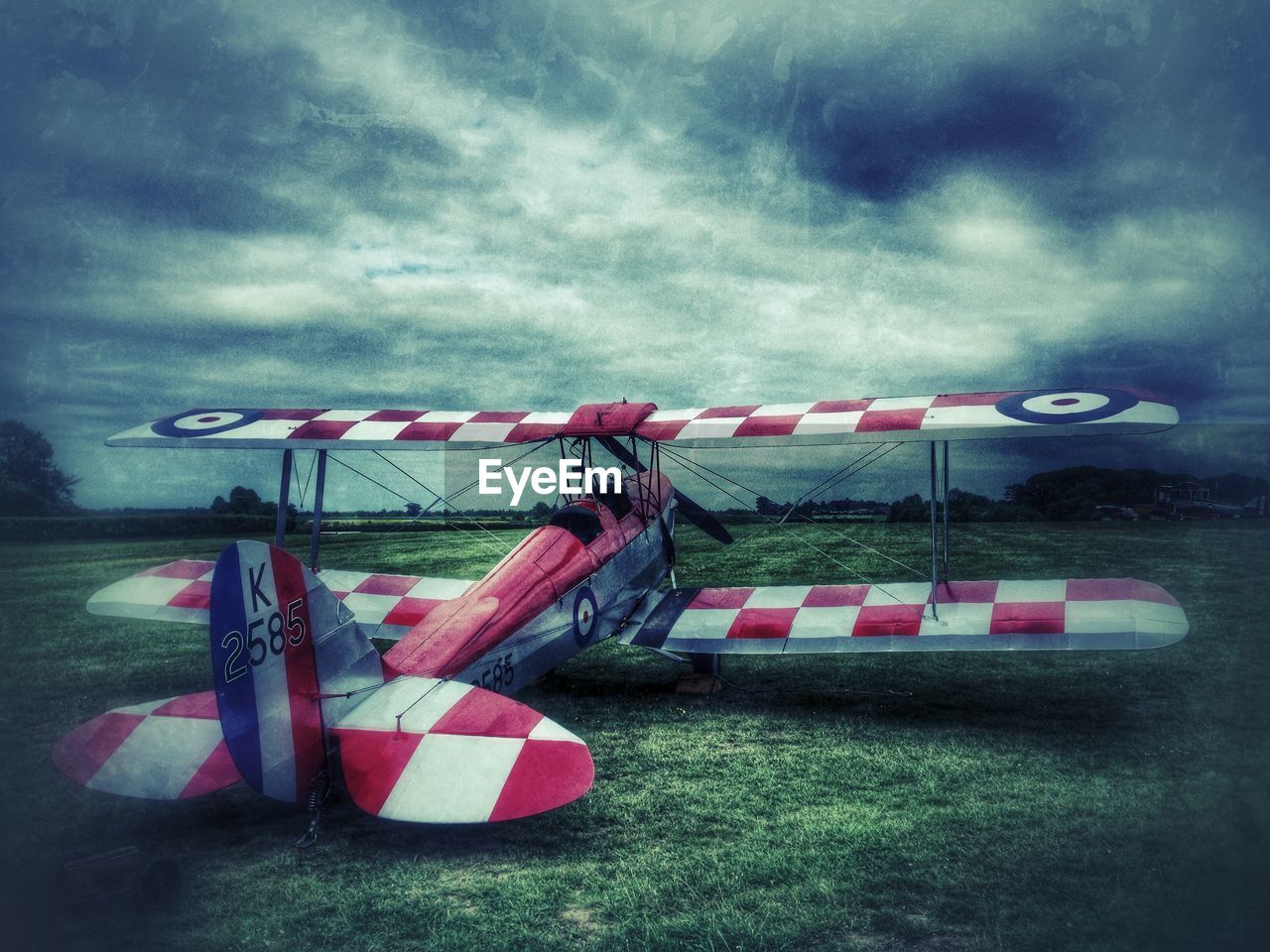 FIELD AGAINST CLOUDY SKY