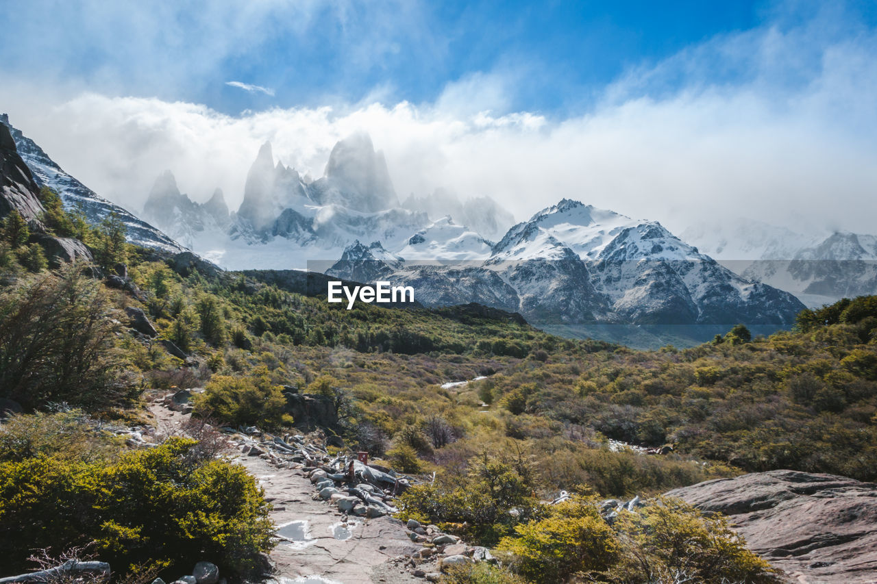 Scenic view of mountains against cloudy sky