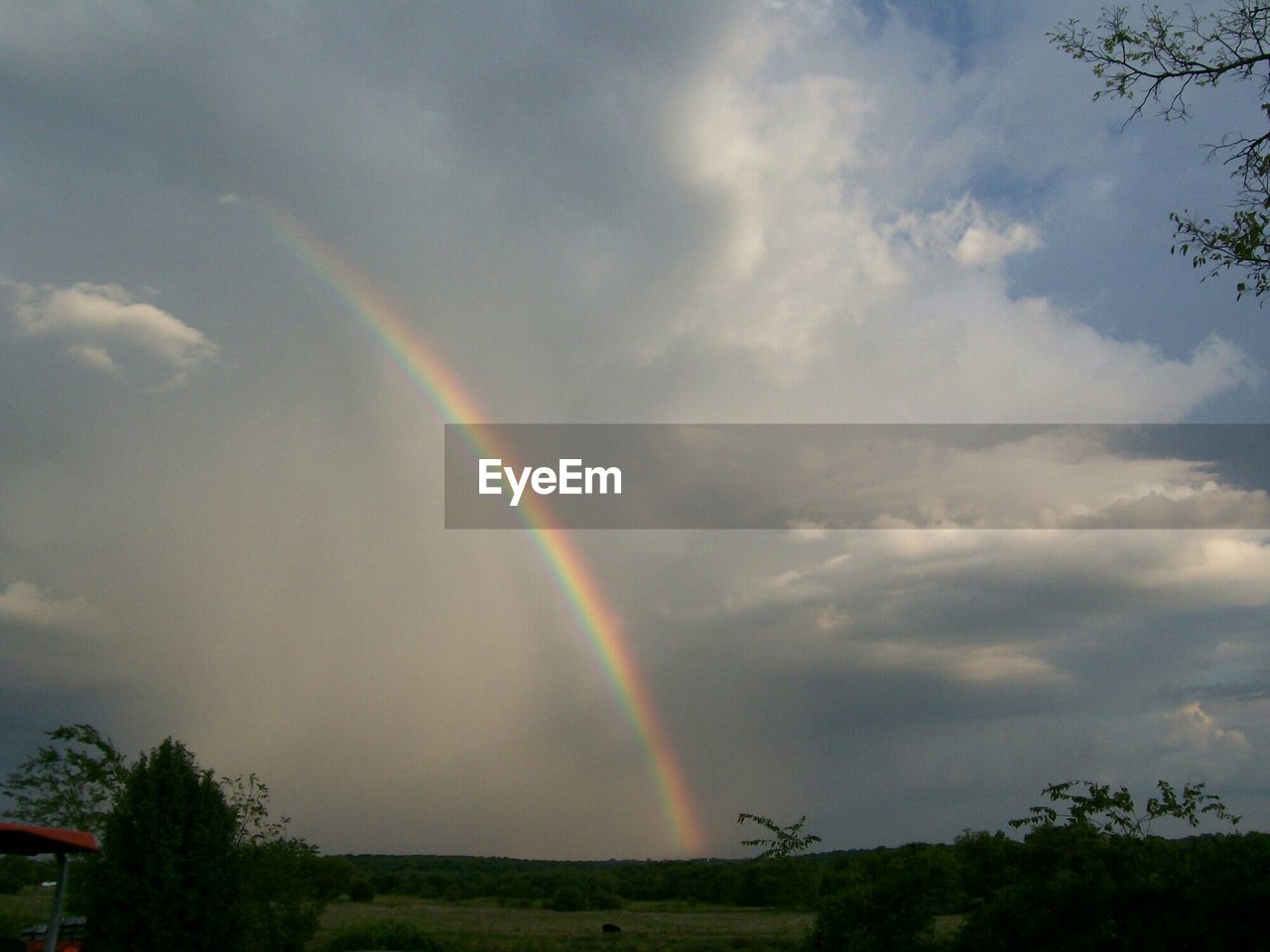 Majestic view of rainbow in sky over landscape