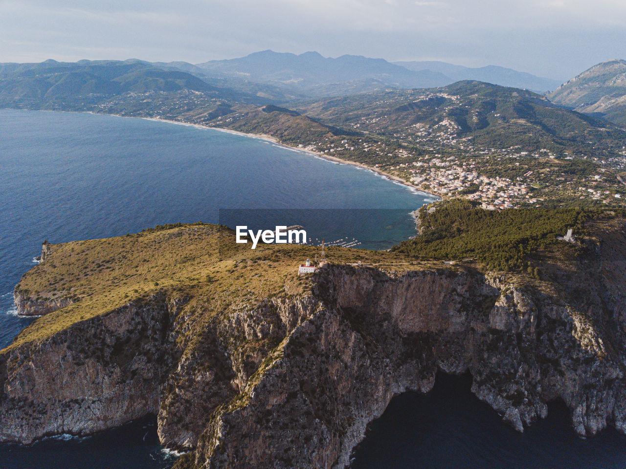 High angle view of sea and mountains against sky