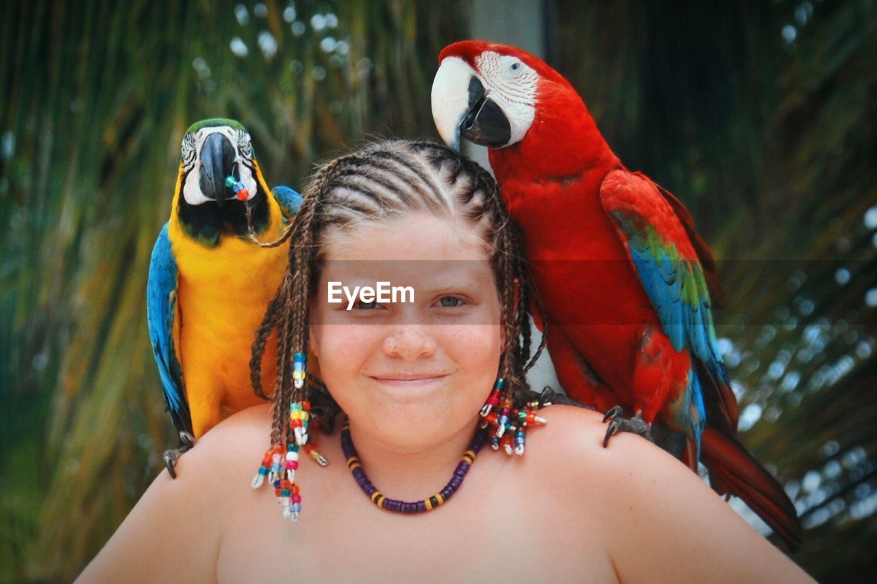 Portrait of girl with parrots