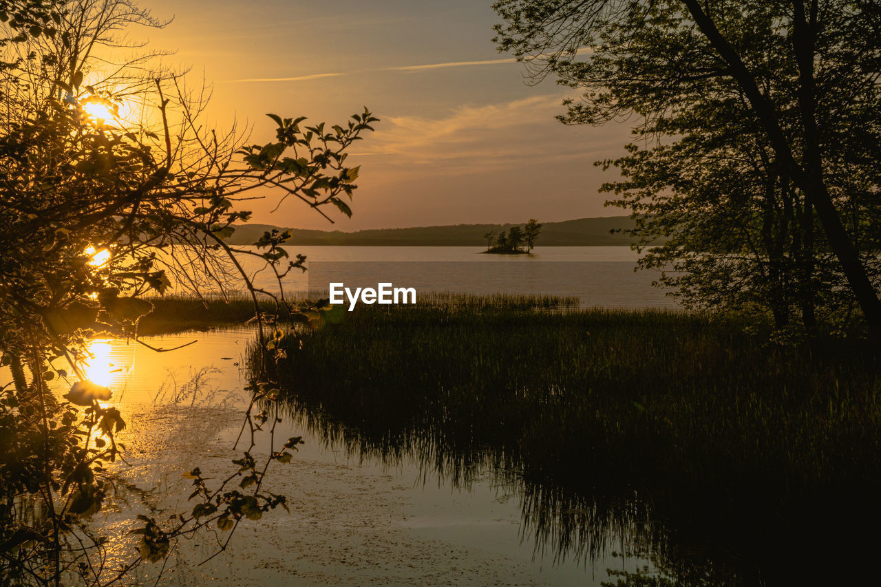 Scenic view of lake against sky during sunset