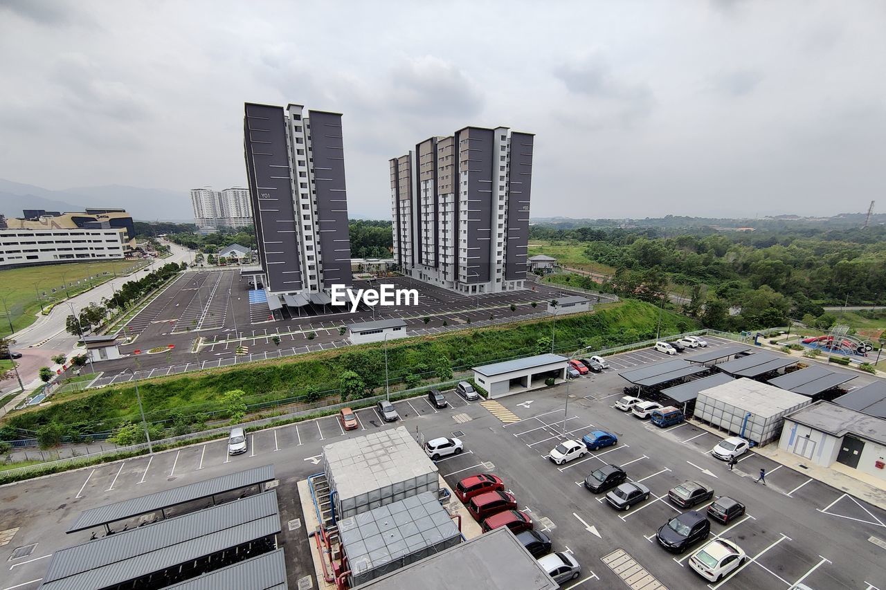 architecture, city, built structure, building exterior, transportation, metropolitan area, road, sky, building, high angle view, residential area, street, mode of transportation, tower block, cloud, motor vehicle, cityscape, car, urban area, aerial photography, highway, downtown, nature, traffic, city street, landscape, office building exterior, transport, city life, skyscraper, residential district, travel, travel destinations, urban skyline, outdoors, skyline, bird's-eye view, day, no people, freeway, business, business finance and industry, downtown district, land vehicle, industry, neighbourhood, public transport, stadium, landmark, overpass