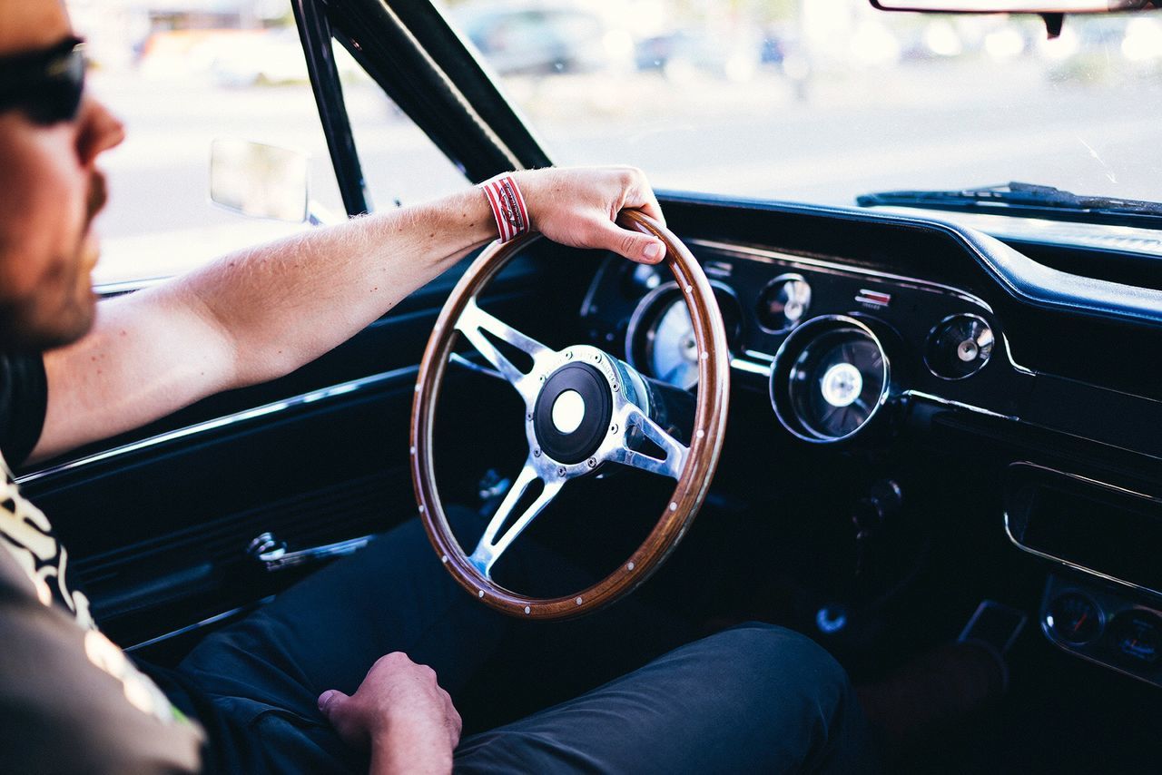 CLOSE-UP OF MAN DRIVING CAR ON WINDSHIELD