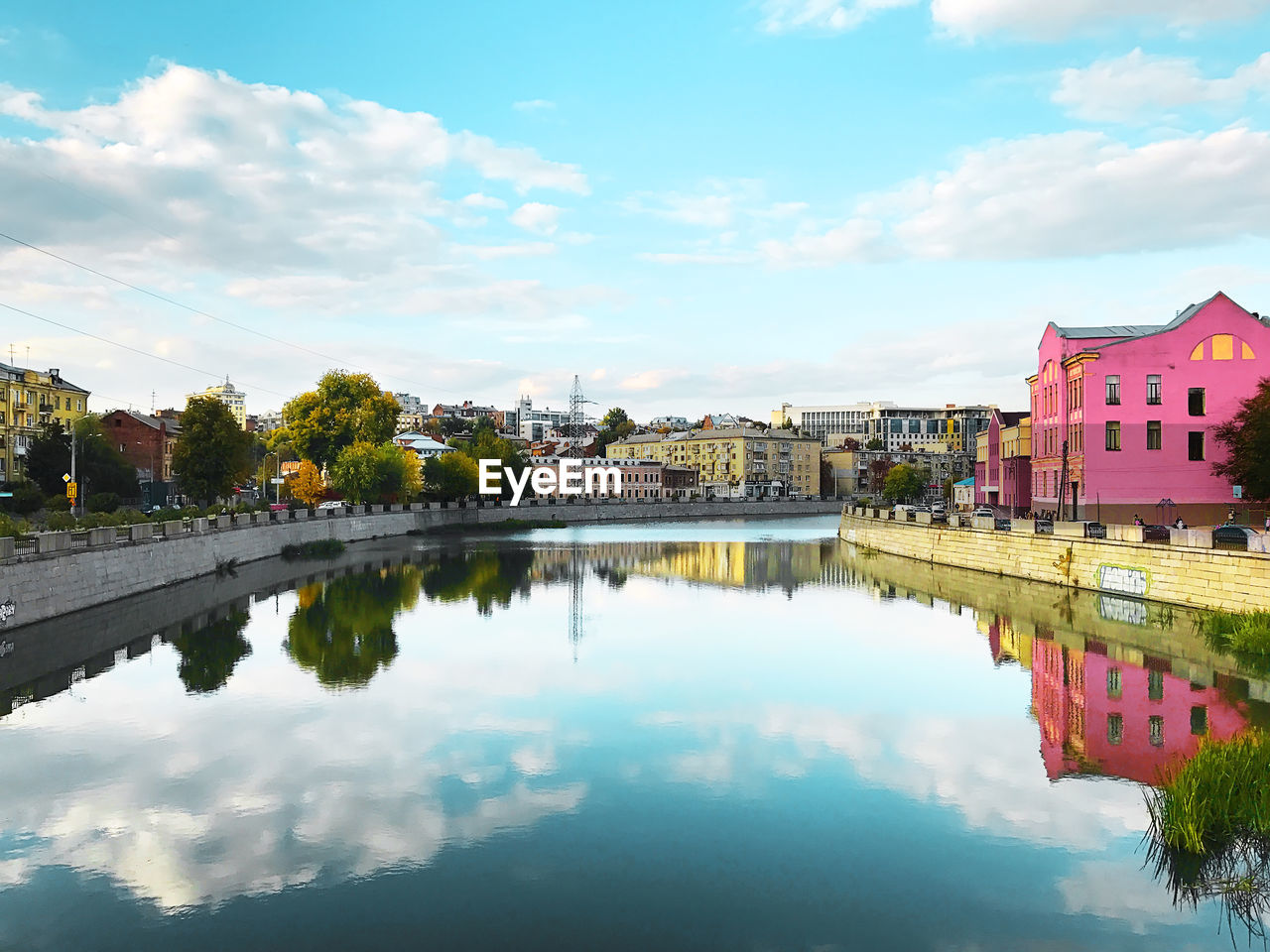 Scenic view of lake by buildings against sky