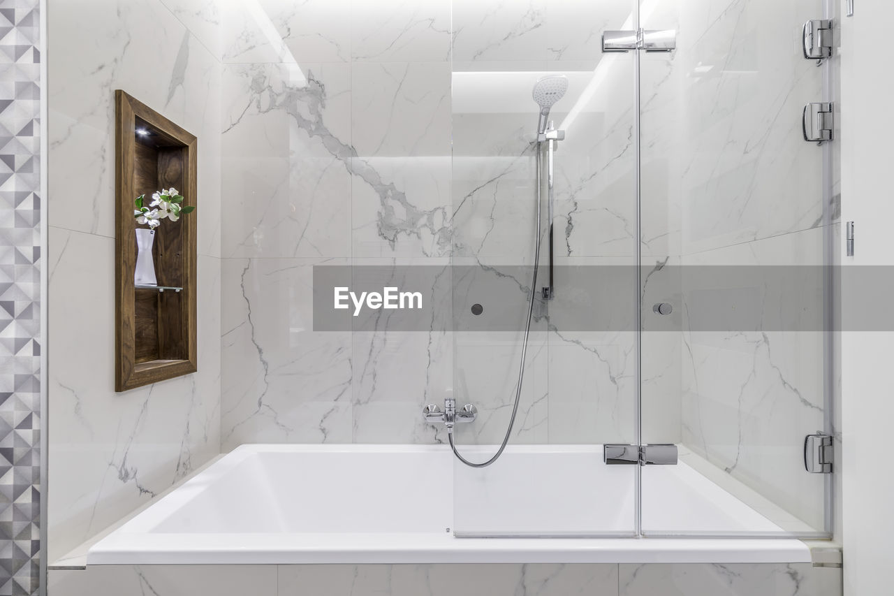 Modern bathroom white marble wall shower. 