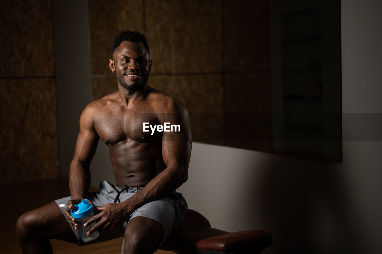 side view of young man exercising in gym