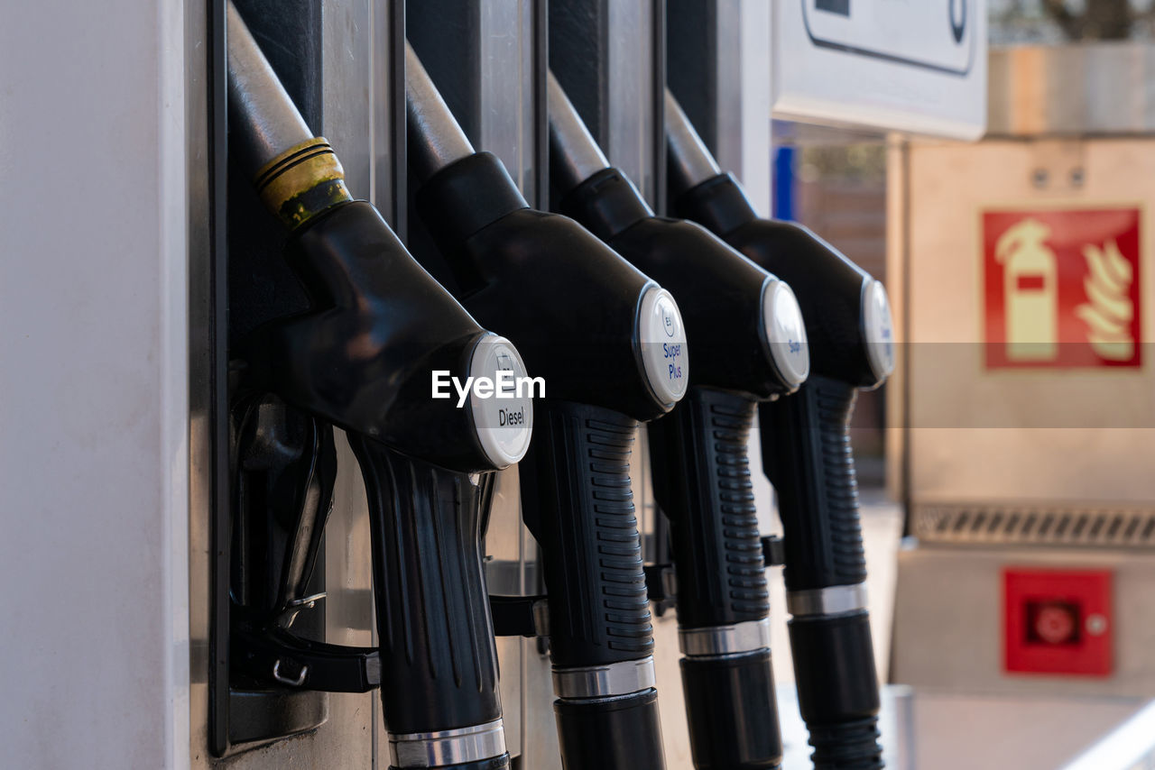 A gas pump nozzles at a gas station. closeup.