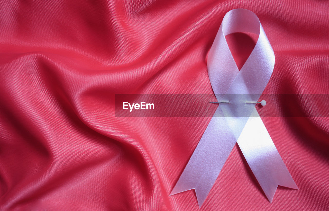 Close-up of breast cancer awareness ribbon on textile