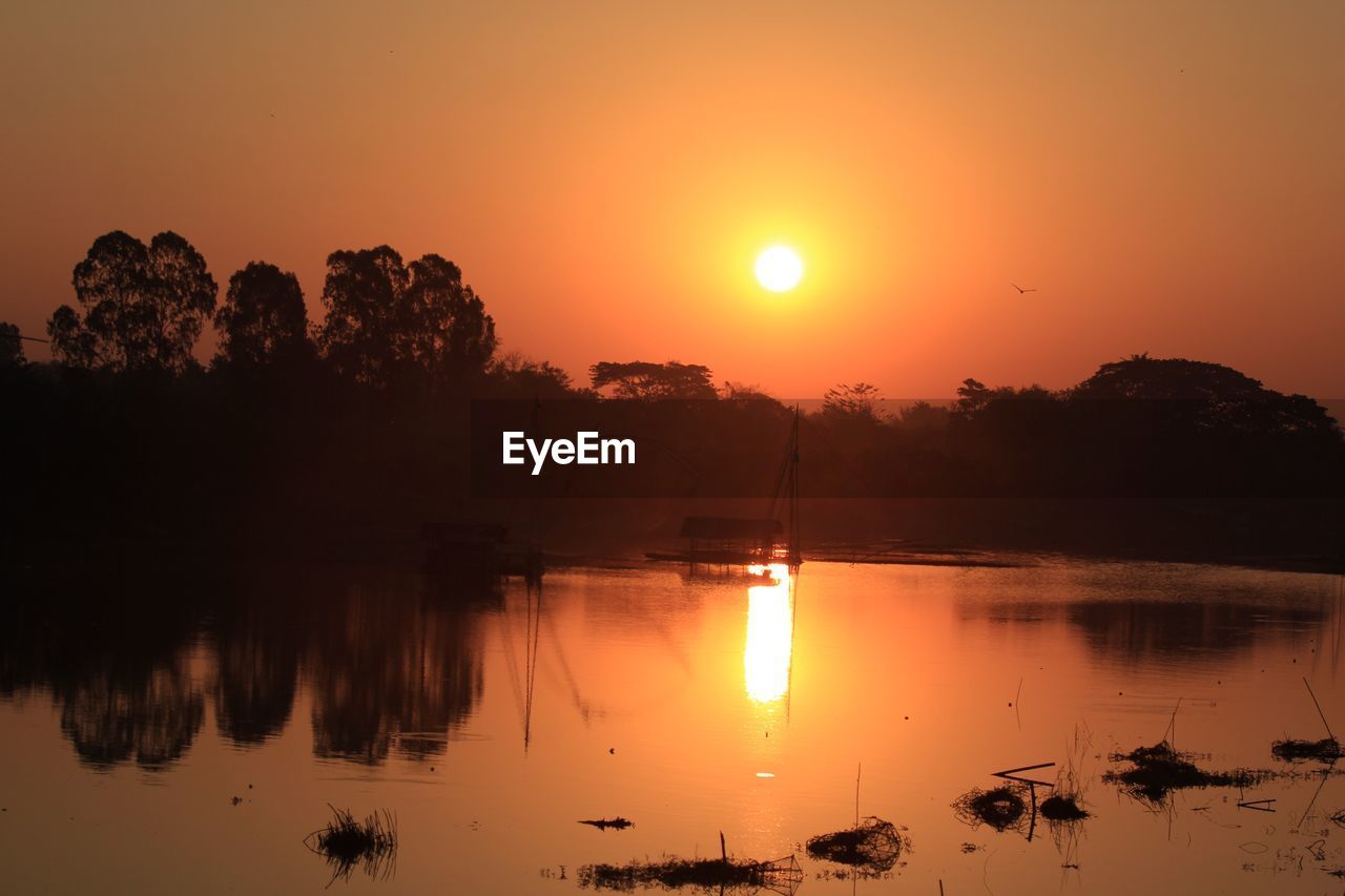 Scenic view of lake against sky during sunset