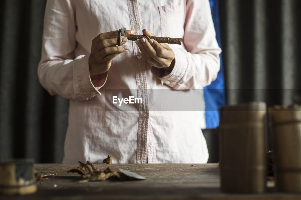 Midsection of man working on table