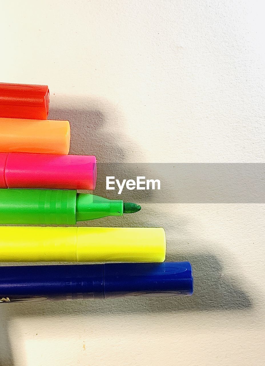 CLOSE-UP OF MULTI COLORED PENCILS ON TABLE