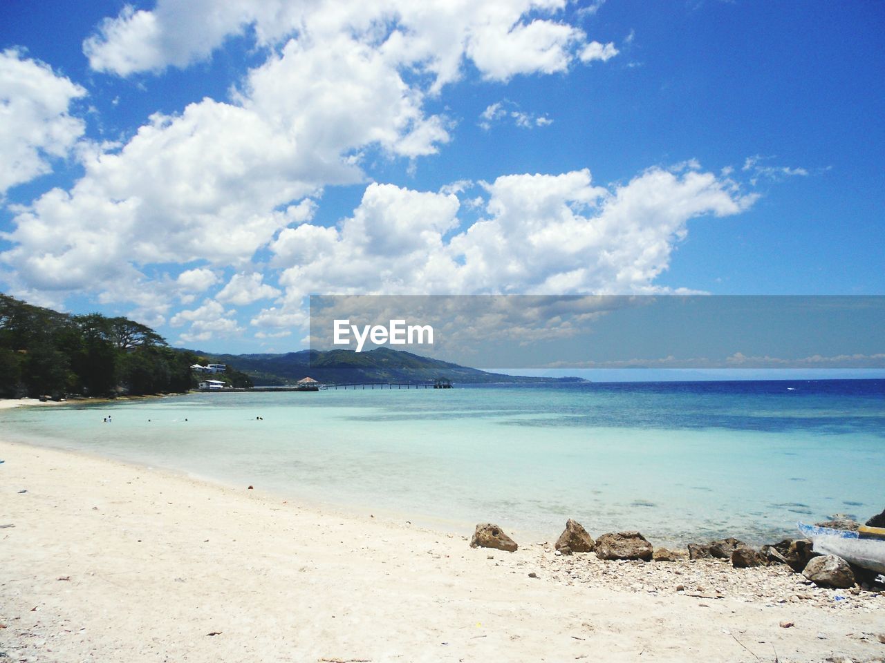 Scenic view of beach against blue sky