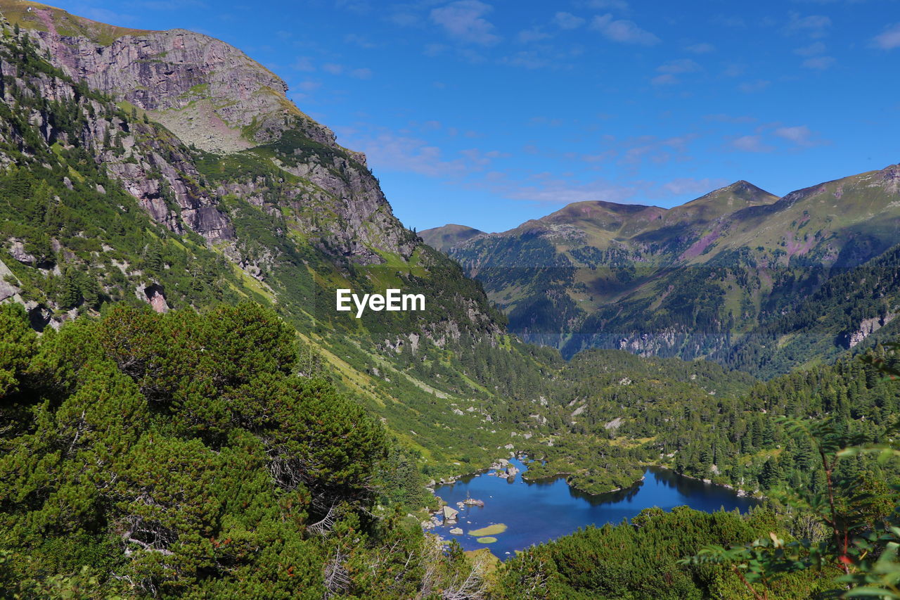 Scenic view of lake and mountains against sky