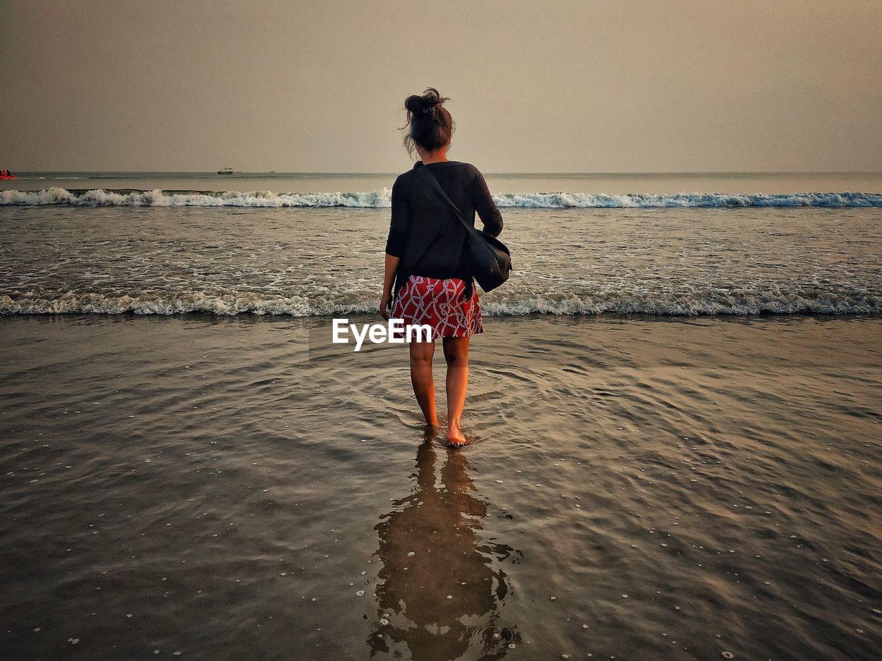 Rear view of girl standing on beach