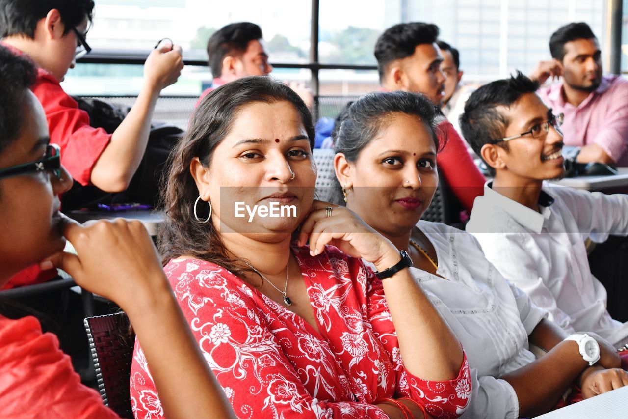 PEOPLE SITTING ON SEAT